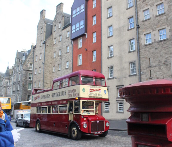 Igor next to a double-decker bus in Edinburgh